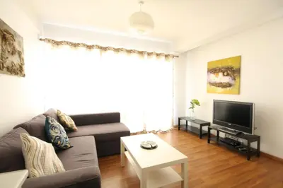 a living room with a couch and a tv at Napa Blue Apartment, XXL Pool,in Hearth of Ayia Napa in Ayia Napa