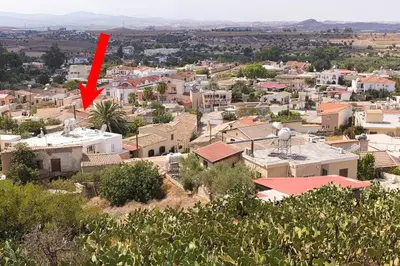 a red arrow pointing to a city with buildings at Avli-the courtyard in Nicosia