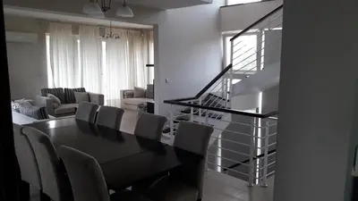 a dining room with a black table and chairs at Saint John Sia house in Nicosia