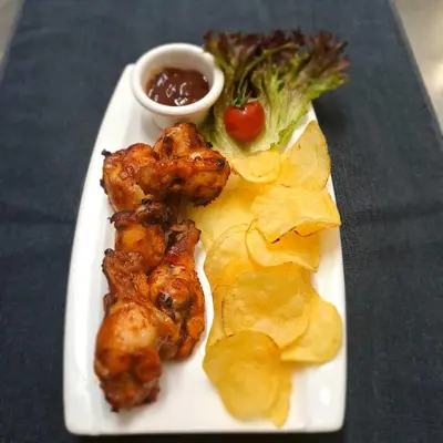 a plate of food with chicken and chips and broccoli at La Veranda Hotel in Larnaka