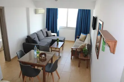 a living room with a couch and a table at Maria Zintili Apartments in Ayia Napa