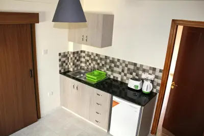 a small kitchen with a sink and a counter at Maria Zintili Apartments in Ayia Napa