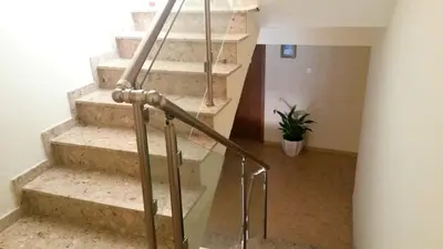 a set of stairs with a glass railing at Maria Zintili Apartments in Ayia Napa