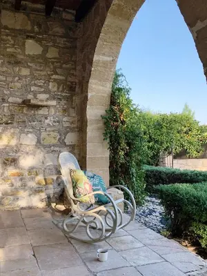 a bench sitting on a patio under a stone wall at The Goathouse in Larnaka