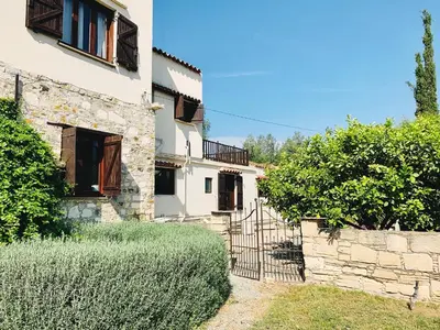 an external view of a building with a gate at The Goathouse in Larnaka
