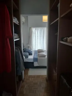 a small bedroom with a bed and a window at Seaside Spacious Apartment with Sea View in Limassol