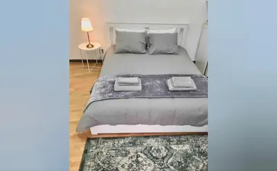 a bedroom with a large bed and a rug at Unique Studios Phaneromenis 41 - Down Town Nicosia in Nicosia
