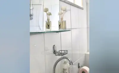 a bathroom with a sink with two shelves on the wall at Unique Studios Phaneromenis 41 - Down Town Nicosia in Nicosia
