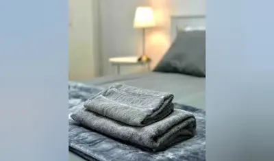 a pile of towels sitting on top of a bed at Unique Studios Phaneromenis 41 - Down Town Nicosia in Nicosia