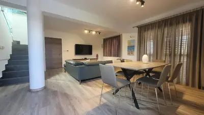 a living room with a table and a couch at Poros 2 Villa in Protaras