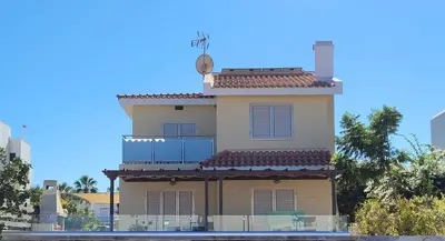 a tall building with a clock on top of it at Poros 2 Villa in Protaras