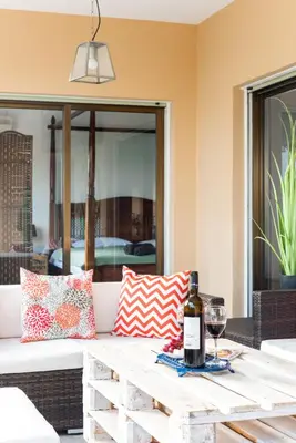 a wooden table with a bottle of wine and a glass at Sun city apartment in Limassol