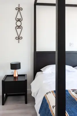 a bedroom with a bed and a table with a lamp at Sun city apartment in Limassol
