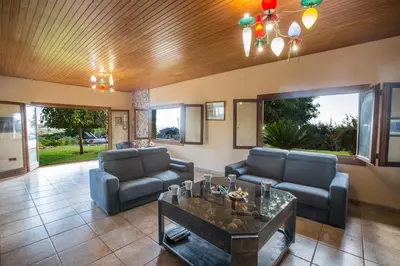 a living room with two couches and a table at Villa Othelo in Ayia Napa