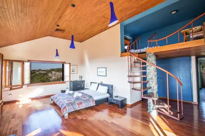 a bedroom with a bed and a staircase at Villa Othelo in Ayia Napa