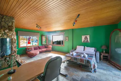 a bedroom with green walls and a wooden ceiling at Villa Othelo in Ayia Napa