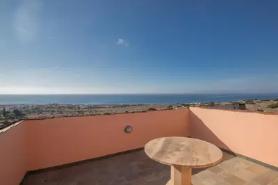 a stool on a balcony with a view of the ocean at Villa Othelo in Ayia Napa
