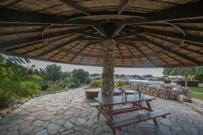 a picnic table under an umbrella on a patio at Villa Othelo in Ayia Napa