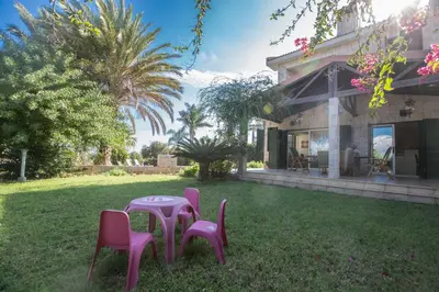 a table and chairs in the yard of a house at Villa Joy in Protaras