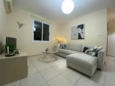 a living room with a couch and a table at Pyla Palms A1 204 in Pyla