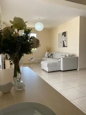 a living room with a couch and a table at Pyla Palms A1 204 in Pyla
