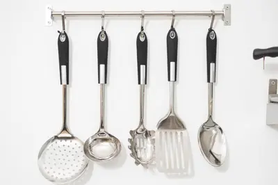 a group of kitchen utensils hanging on a rack at Olympia flat 201 in Larnaka
