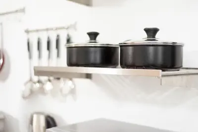 two pots sitting on a shelf in a kitchen at Olympia flat 201 in Larnaka