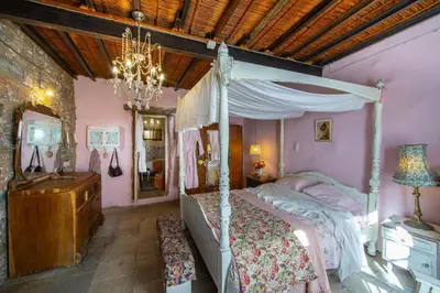 a bedroom with a canopy bed and a chandelier at Tina's Country Home in Askas
