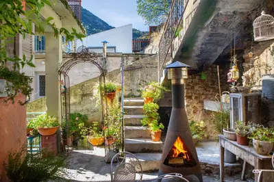 an outdoor kitchen with a fireplace in a courtyard at Tina's Country Home in Askas