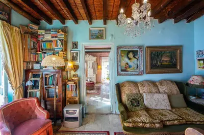 a living room with a couch and books at Tina's Country Home in Askas