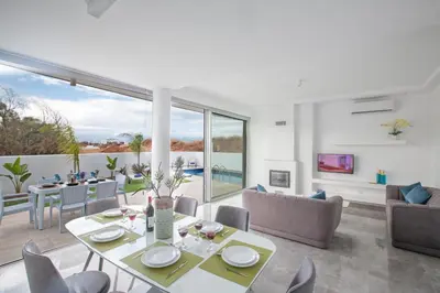 a living room with a table and chairs at Oli Vine Villas in Protaras