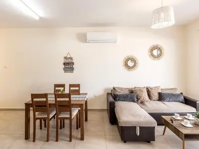 a living room with a couch and a table at Mythical Resort by KARMA in Paralimni
