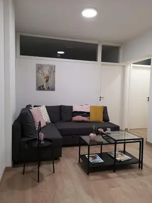 a living room with a couch and two tables at Nemesis in Larnaka