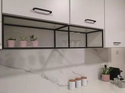 a kitchen with a counter with four plants in pots at Nemesis in Larnaka