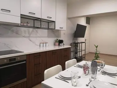 a kitchen with a table with white plates on it at Nemesis in Larnaka