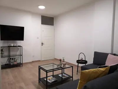 a living room with a couch and a table at Nemesis in Larnaka