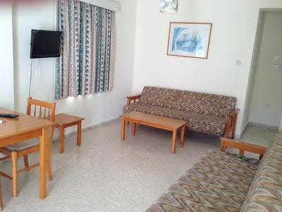 a living room with a couch and a table at Constantaras Apartments in Protaras