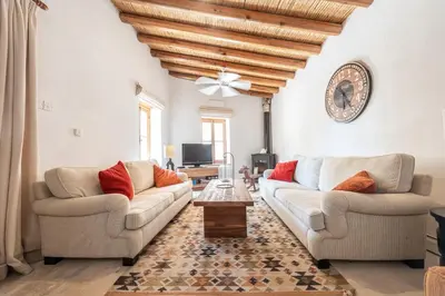 a living room with two couches and a table at The Carob Tree Villa - Rustic Luxury Home With Access To Pool And Restaurant in Larnaka