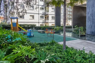 a playground in a courtyard in a building at Carmencita Studio B14 with pool in Limassol