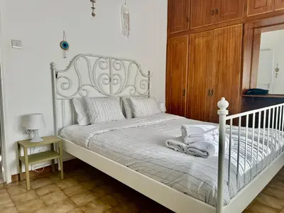 a white bed with towels on it in a bedroom at Tsimintia Apt 25 in Larnaka