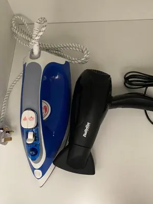 a blue and black hair dryer and a corded handset at Tsimintia Apt 25 in Larnaka
