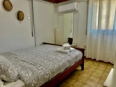 a bedroom with a bed with a teddy bear on it at Tsimintia Apt 25 in Larnaka