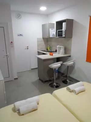 a kitchen with two stools and a counter in a room at Elenapa Holiday Apartments in Ayia Napa