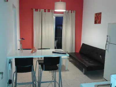 a living room with a table and chairs and a couch at Elenapa Holiday Apartments in Ayia Napa