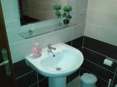 a white sink in a bathroom with a mirror at Elenapa Holiday Apartments in Ayia Napa