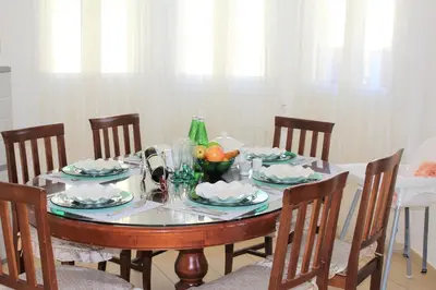 a dining room table with a bowl of fruit on it at Natali villa in a perfect location in Paralimni