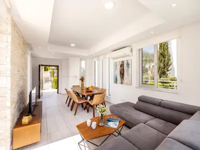 a living room with a couch and a table at Villa Zoe in Protaras