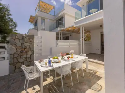 a white table and chairs in front of a house at Villa Zoe in Protaras