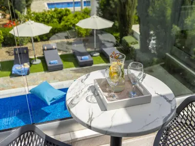 a table with two wine glasses on top of it at Villa Zoe in Protaras