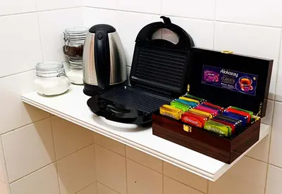 a kitchen counter with a tea pot and books at Youthfull Escape in Nicosia in Nicosia
